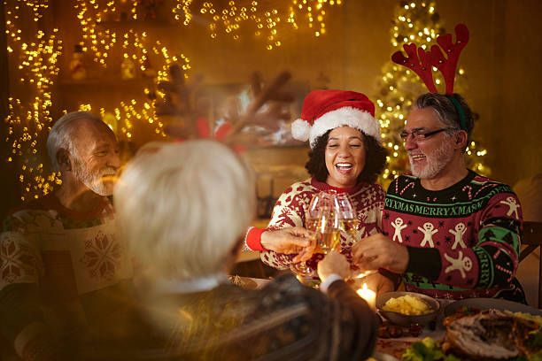 istock Happy senior couples toasting during lunch on New Year's at home. 2222854304