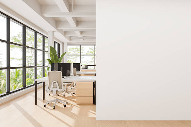 istock Modern office interior with empty white wall for poster mockup or advertising template in bright space with clean design and natural light exposure. 3D Rendering 2222855061