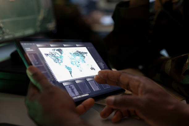 istock Military officer conducts tactical reconnaissance in war room, utilizing tablet 2222855597