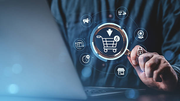 istock Hand holding magnifying glass over digital shopping cart icon interface concept. 2222855908