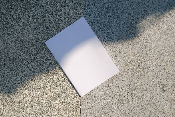 istock empty magazine mockup on concrete stone floor or pavement outdoors, shadow overlay 2222855997