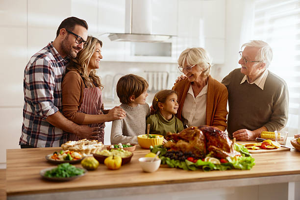 istock Happy extended family talking on Thanksgiving in the kitchen. 2222856108