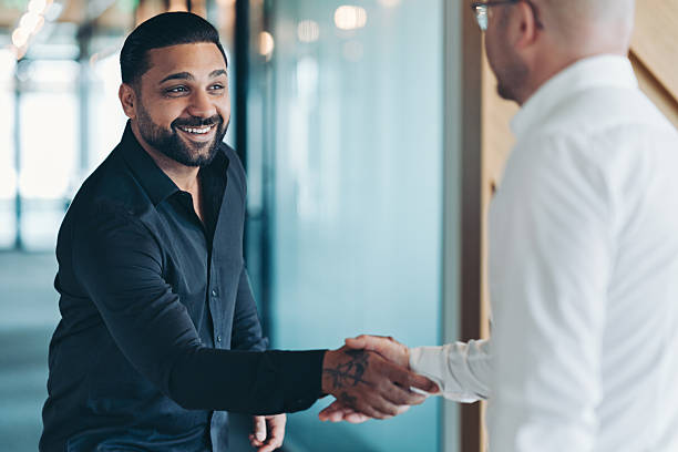 istock Smiling businessman congratulating a customer 2222856458