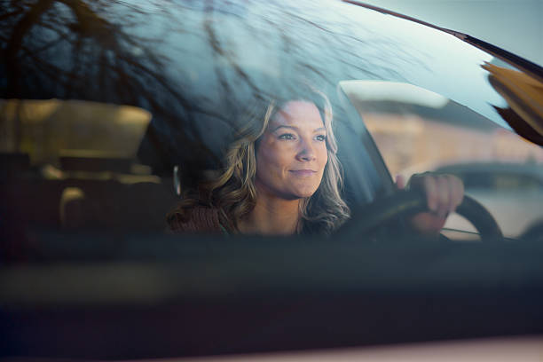 istock Smiling woman going on a road trip by car. 2222858032