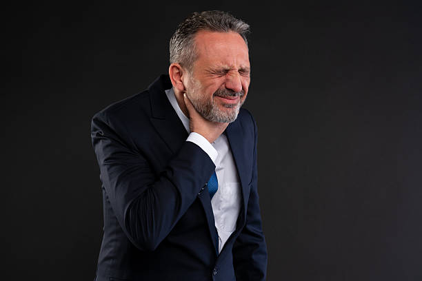istock Businessman in pain touching neck 2222862367