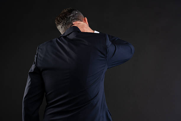 istock Businessman with neck pain seen from behind 2222862401