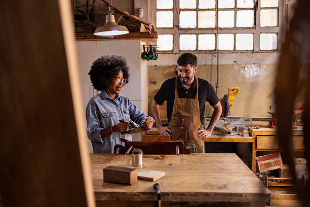 istock Two craftsmen collaborating in a traditional woodworking workshop atmosphere 2222864399