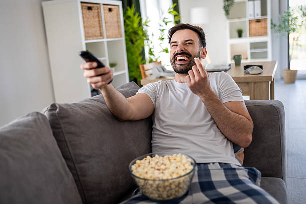 istock Handsome Man with Popcorn and Remote in Pajamas 2222865155