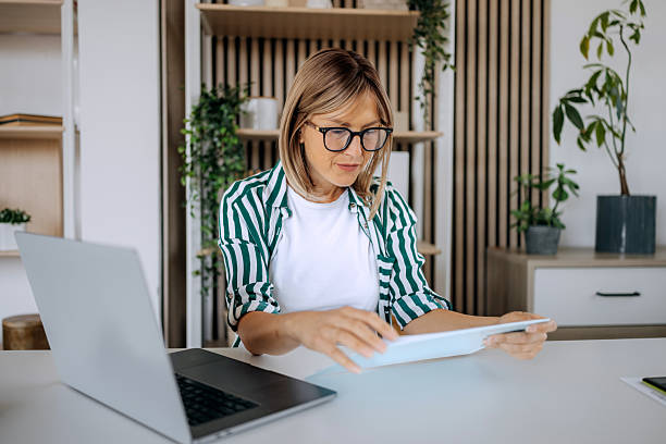istock Woman using laptop at home office desk 2222866225