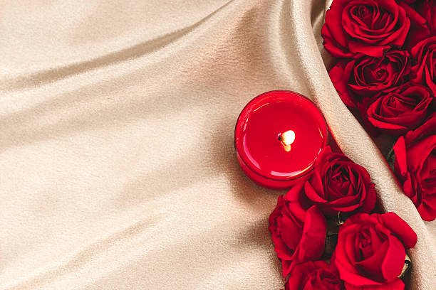 istock Romantic setting with red roses and candle on soft fabric for special occasions 2222866893