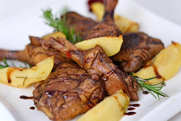 roasted duck leg with mashed potatoes and fresh salad on the plate closeup. horizontal view from abovel . High quality photo