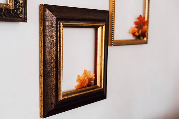 istock Decorative empty frames with colorful leaves displayed on a white wall in an indoor setting 2222867494