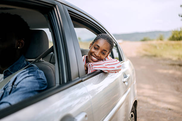 istock Woman enjoying breeze while riding in back seat 2222869029