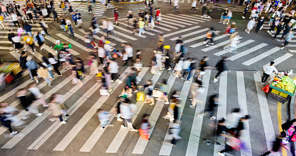 istock Motion blurred crowd of people walking on crosswalk 2222869638