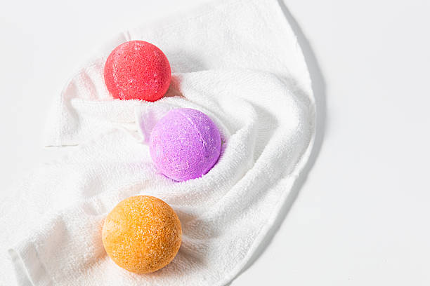 istock Colorful bath bombs arranged on a fluffy towel showcasing vibrant hues and textures 2222869661