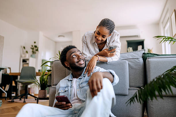 istock Young couple using smartphone together at home 2222869820
