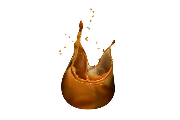 istock Dynamic caramel splash isolated over a white background. Delicious sweet caramel syrup with a splashing effect 2222870419