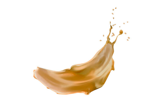 istock Dynamic caramel splash isolated over a white background. Delicious sweet caramel syrup with a splashing effect 2222870463