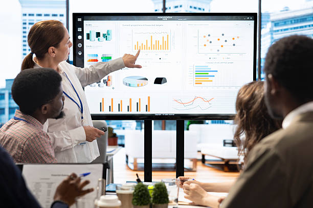 istock Staff members and shareholders gathering for a reports analysis in boardroom 2222870687