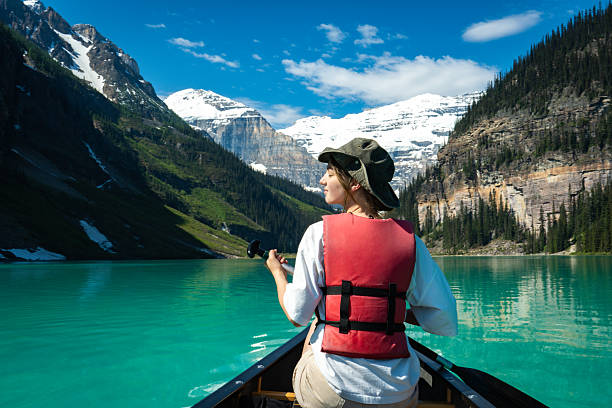 istock Person paddling canoe on turquoise lake 2222873636
