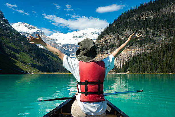 istock Canoe on mountain lake with person 2222873851