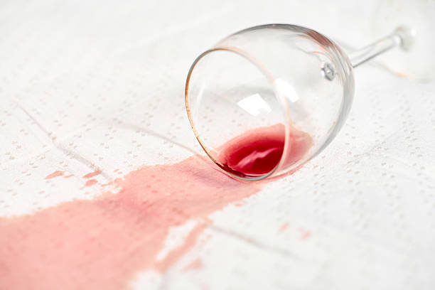 istock Red wine spill on white cloth with glass on side 2222874654