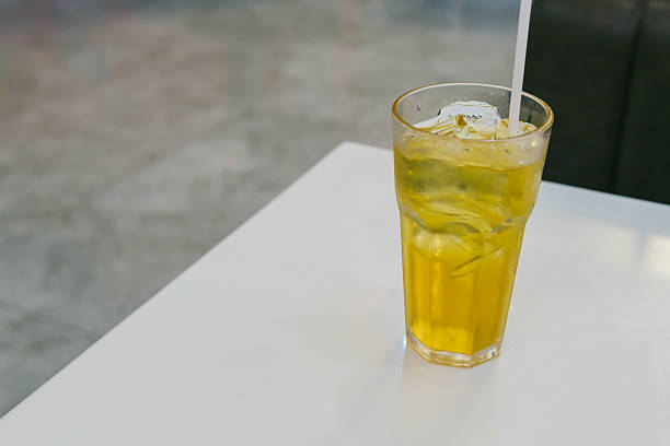 istock Refreshing glass of iced tea with lemon and ice on a white table in a modern cafe setting 2222878061