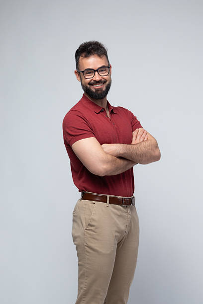 istock Smiling Confident Man in Red Polo with Arms Crossed 2222878084