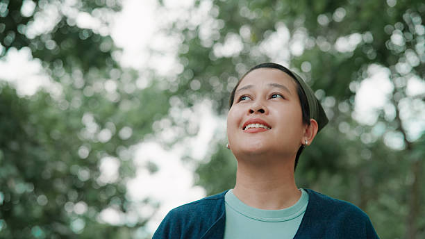 istock Asian woman walking in public park 2222878246