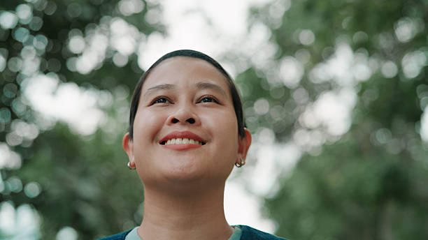 istock Asian woman looking at view in public park 2222878588
