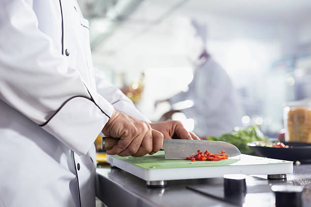 istock Professional chef chopping fresh veggies in a commercial kitchen 2222878834