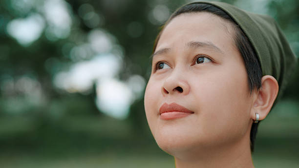Asian woman looking at view in public park