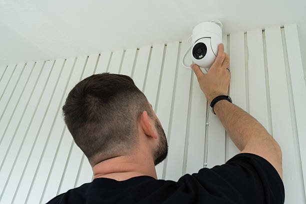 istock A professional technician installs a rotating surveillance camera on a house wall. Installation and setup of modern security and smart home systems. 2222881358