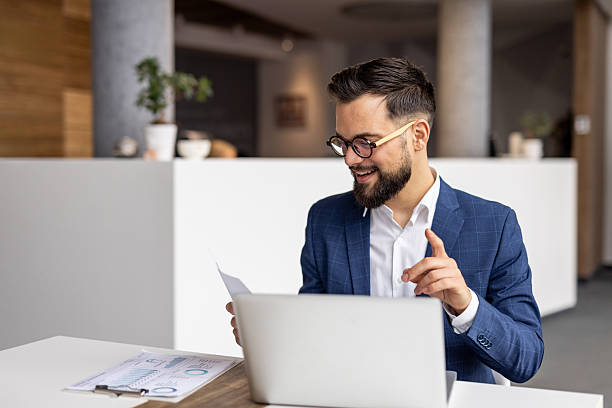 istock Young businessman having a video call and discussing a document 2222881599