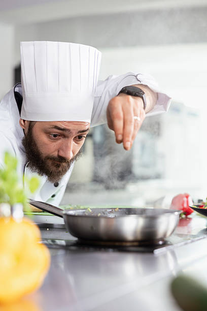 istock Culinary arts meet precision as a chef sprinkles parsley over a gourmet dish 2222882405