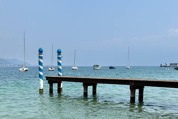 Summer holiday: Wooden dock pier over blue lake water