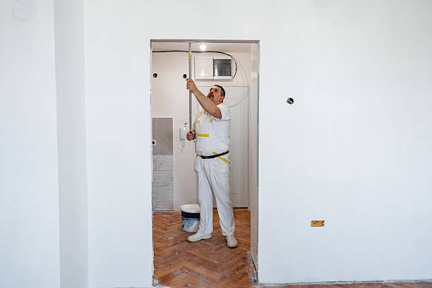 istock Mature Worker Painting The Ceiling With A Paint Roller In An Empty Apartment Under Renovation 2222883319