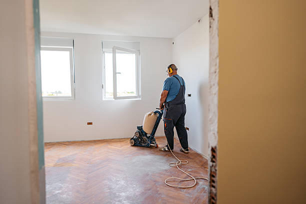 istock Mature Worker Sanding A Parquet Floor In An Empty Apartment Under Renovation 2222884847