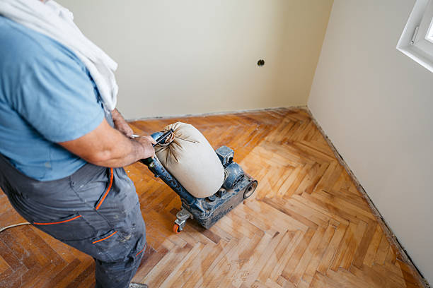 istock Mature Worker Sanding A Parquet Floor In An Empty Apartment Under Renovation 2222884872