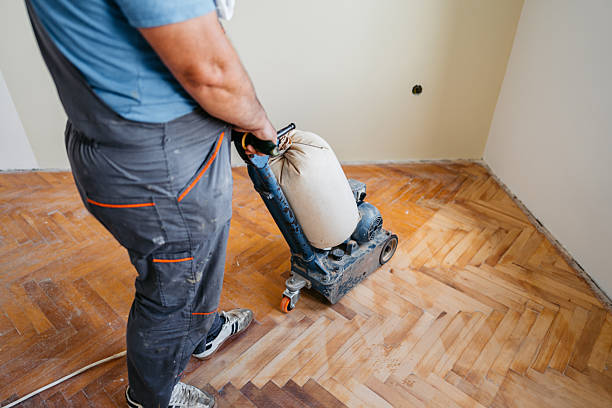istock Mature Worker Sanding A Parquet Floor In An Empty Apartment Under Renovation 2222885430