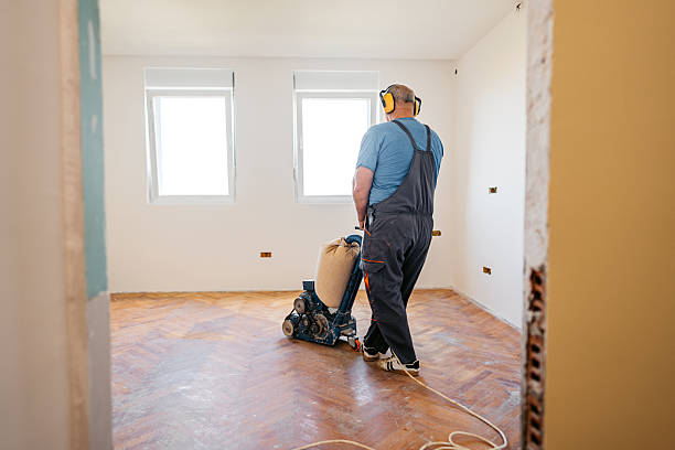 istock Mature Worker Sanding A Parquet Floor In An Empty Apartment Under Renovation 2222885600