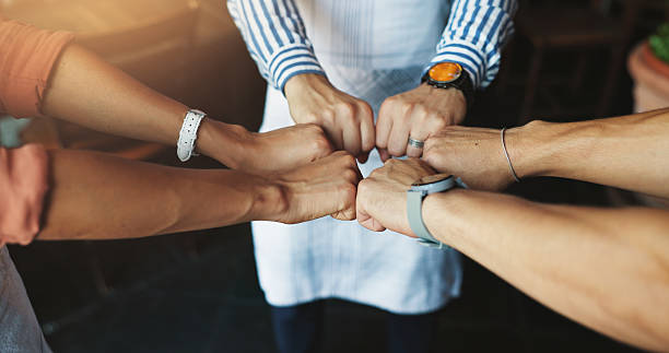 istock Teamwork, fist bump and cafe with support, huddle and friendly service with hospitality. Group, barista and employees in coffee shop, hand gesture and cooperation with collaboration and thank you 2222888780