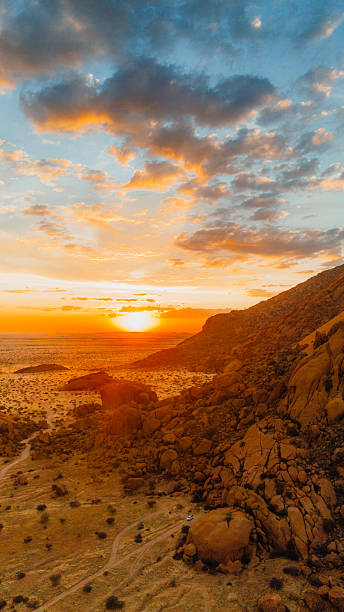istock Aerial View of Awe-Inspiring Sunset Above Car Camping in Spitzkoppe Cliffs, Namibia 2222889047