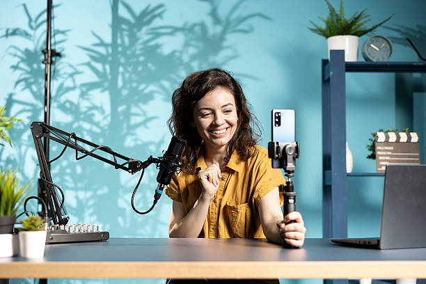 istock Happy woman using phone camera to record vlog for podcasting channel 2222889167