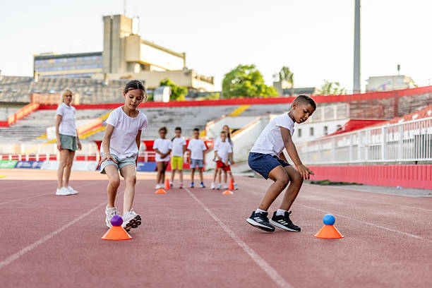 istock Children Practicing Coordination Skills During Track and Field Training Outdoors 2222891948
