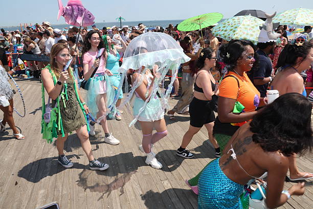 People gather on the boardwalk on the final stretch of the Mermaid Parade on Surf Avenue in Coney Island, N.Y., Saturday, June 21, 2025.