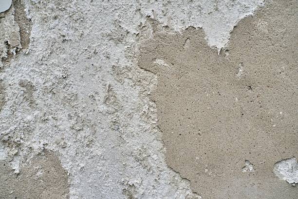 istock Textural Abstraction of Weathered Cement and Plaster with Gritty Surface Details and Peeling Paint Layers 2222897204