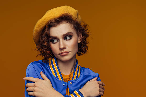 istock Pensive Woman in Blue and Yellow with a Melancholic Expression 2222898102