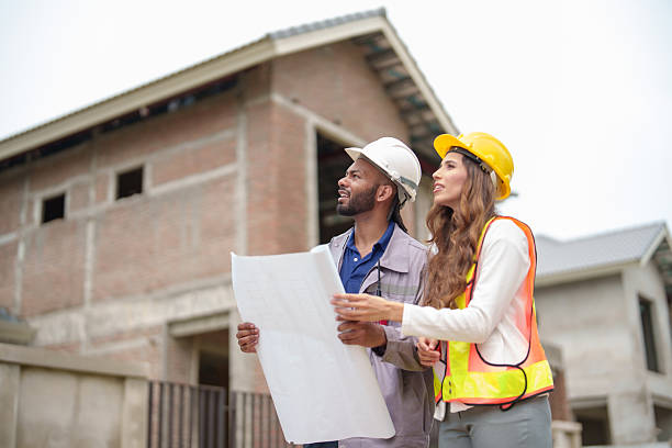 istock Construction teamwork man and woman engineers with helmets discussing plan blueprint indoors site. 2222899852