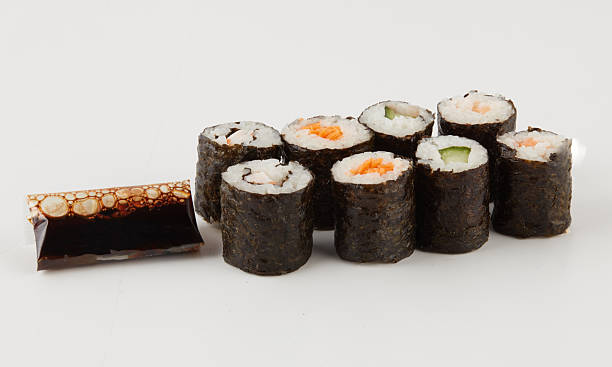 Sushi rice balls wrapped in seaweed with sauce isolated nature background with clipping path